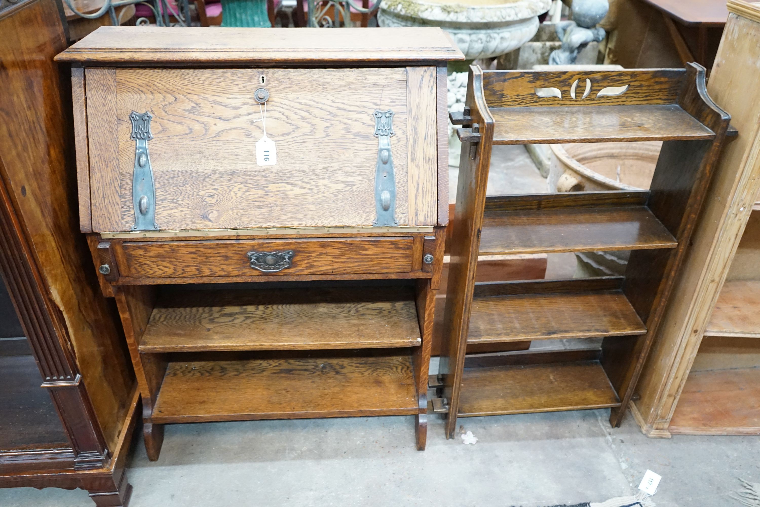 An Edwardian Art Nouveau oak student's desk, width 76cm, height 100cm together with a smaller open bookcase